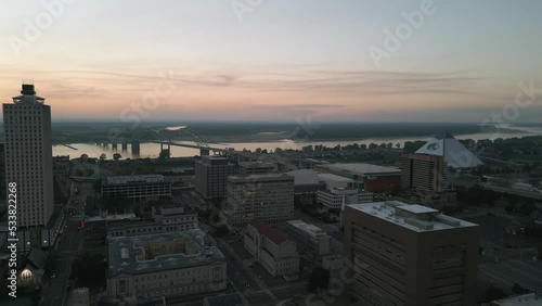 Drone Flying during Sunset around Buildings in Downtown Memphis, Tennessee with the Mississippi River Bridge in the background.