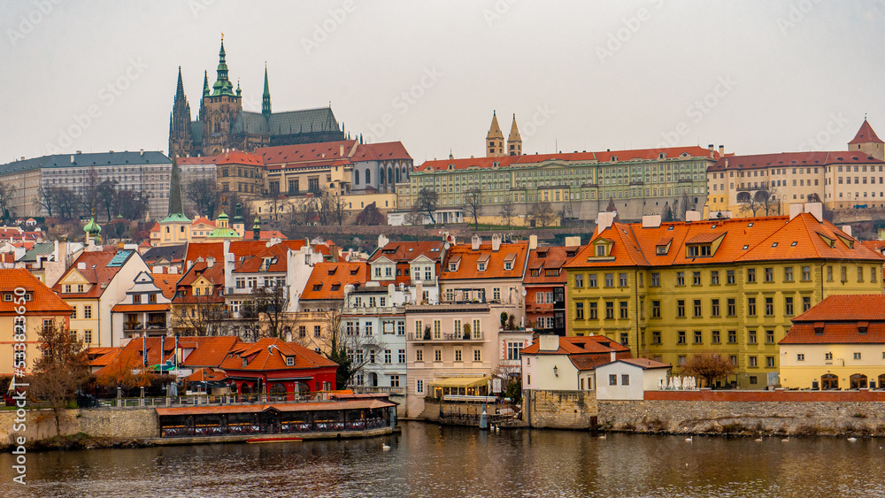 Beautiful view , buildings , cityscape from Charles bridge in Prague old town , medieval stone arch bridge along Vltava River during winter . Prague , Czech  : December 12 , 2019