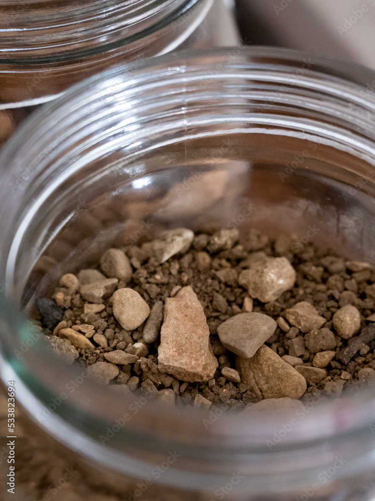 Different samples of soils in Climat of origin, grand cru wine tasting in underground cellars caves of French wine domain in Puligny-Motrachet village, Burgundy, France Different samples of soils in Climat of origin, grand cru wine tasting in underground cellars caves of French wine domain in Puligny-Motrachet village, Burgundy, France