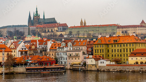 Beautiful view , buildings , cityscape from Charles bridge in Prague old town , medieval stone arch bridge along Vltava River during winter . Prague , Czech : December 12 , 2019