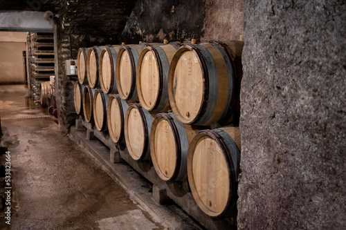 Stages of wine production from fermentation to bottling, visit to wine cellars in Burgundy, France. Aging in wooden barrels.