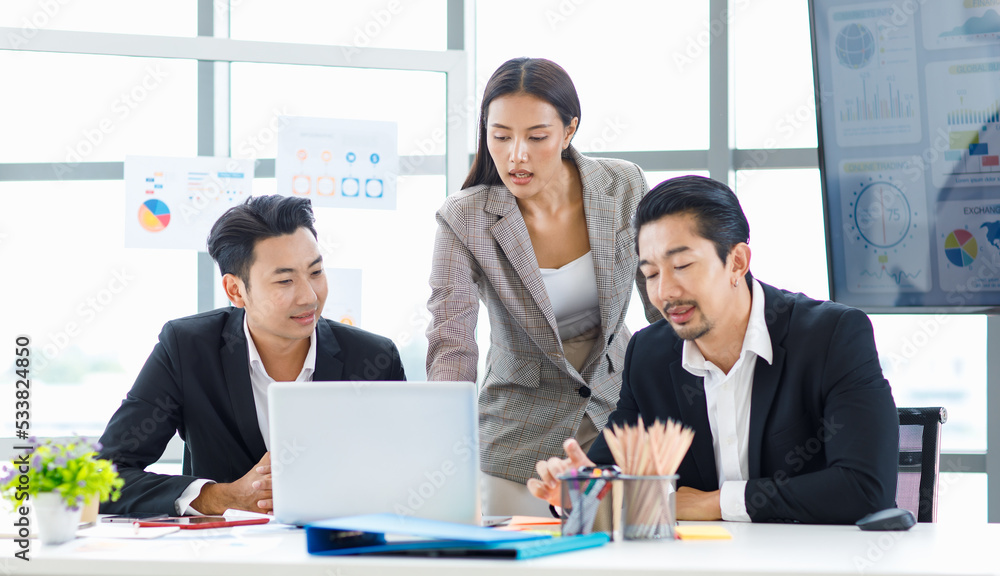 Millennial Asian cheerful happy professional successful male businessman and female businesswoman colleague in formal suit smiling brainstorming discussing talking in company office meeting room. Millennial Asian cheerful happy professional successful male businessman and female businesswoman colleague in formal suit smiling brainstorming discussing talking in company office meeting room.