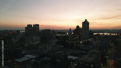 Drone Flying during Sunset around Buildings in Downtown Memphis, Tennessee with the Mississippi River Bridge in the background.