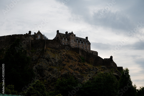 View from Princes street to old town and castle in Edinburgh city, view on houses, hills and trees in old part of the city, Scotland, UK