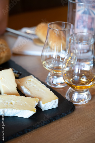 Pairing of scotch whisky and farmers scottish cheeses cheddar, stilton, blue cheese, brie, tasting of whiskey and cheese in Edinburgh, UK