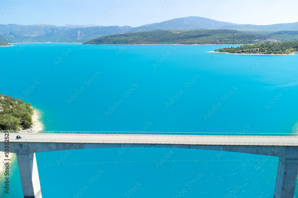 Aerial view on blue lake Sainte-Croix-du-Verdon, road bridge and cliffs, tourists destination in France Aerial view on blue lake Sainte-Croix-du-Verdon, road bridge and cliffs, tourists destination in France