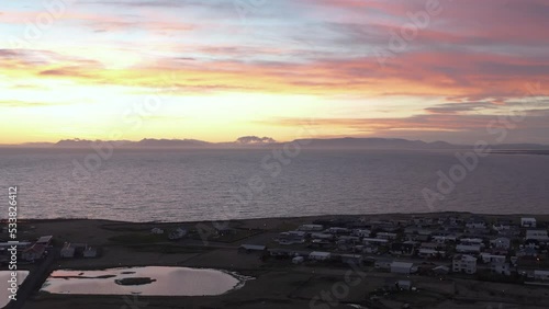 Colorful sunset at Njarðvík town on Iceland coast, aerial photo