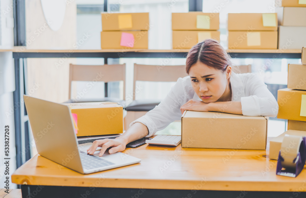 Online small business owners are sad and bored waiting for orders that haven't yet arrived. Online Retailers - Online Shopping Online small business owners are sad and bored waiting for orders that haven't yet arrived. Online Retailers - Online Shopping