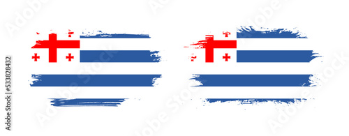 Set of two grunge brush flag of Adjara on solid background