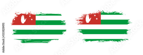 Set of two grunge brush flag of Abkhazia on solid background