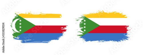 Set of two grunge brush flag of Comoros on solid background