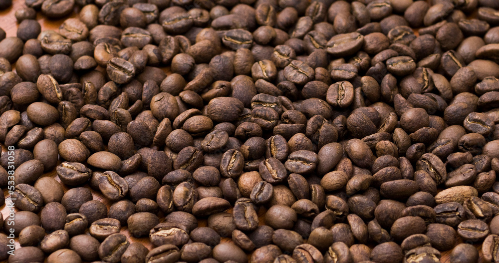 Fototapeta premium Texture roasted coffee beans close up toasted brown