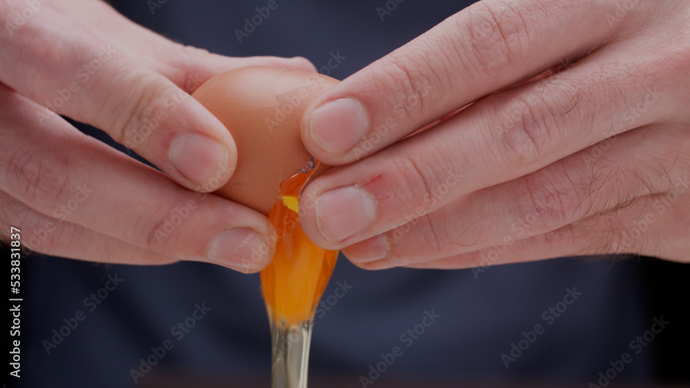 close up of hands breaking egg for cooking cracking