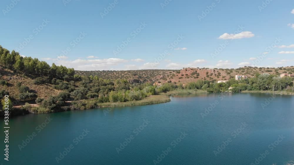 Natural Park of Lagunas de Ruidera in Spain. Panning shot through blue water Natural Park of Lagunas de Ruidera in Spain. Panning shot through blue water