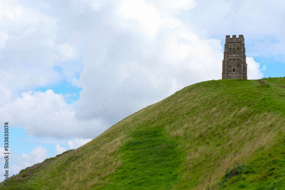 A view of popular religious tourism landmark of historic St. Michael's Tower on Glastonbury Tor in Glastonbury, Somerset England UK