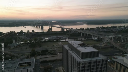 Drone Flying during Sunset around Buildings in Downtown Memphis, Tennessee with the Mississippi River Bridge in the background.