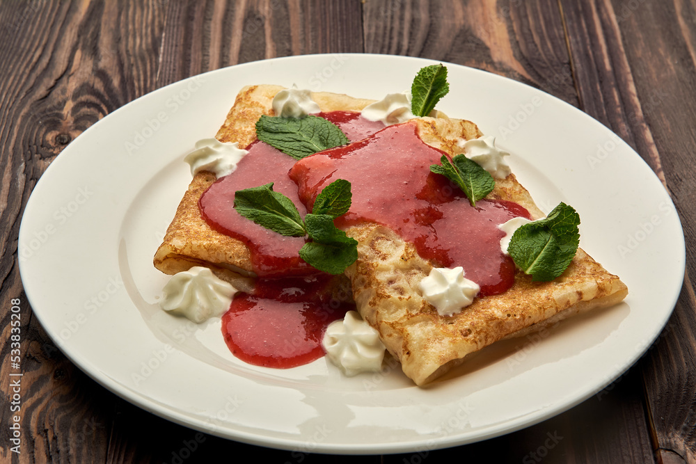 delicious juicy pancakes drizzled with sauce are served on a white plate delicious juicy pancakes drizzled with sauce are served on a white plate