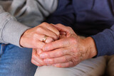 Hands of senior couple holding together, care and support