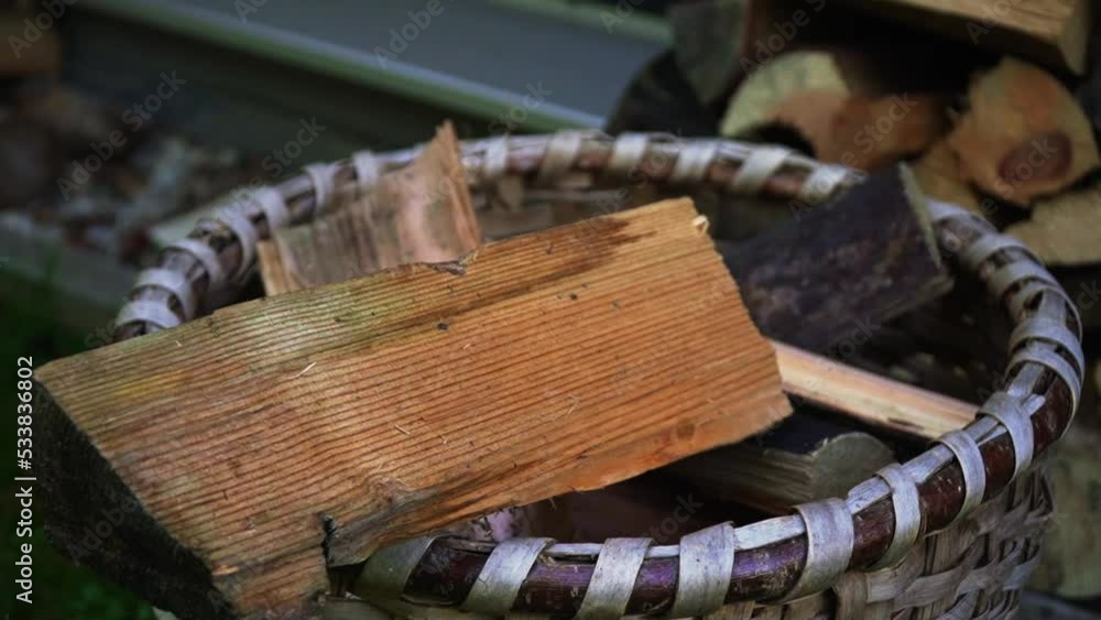 Throwing a brick of chopped wood in the sack or basket to make a fire Throwing a brick of chopped wood in the sack or basket to make a fire