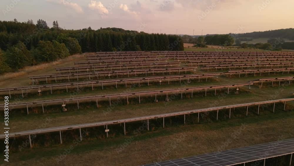 Slow Flight Over A Solar Panel Field During A Stunning Sunset In Germany Slow Flight Over A Solar Panel Field During A Stunning Sunset In Germany