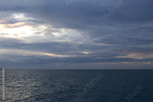 Calm sea with sunset sky with cloud.