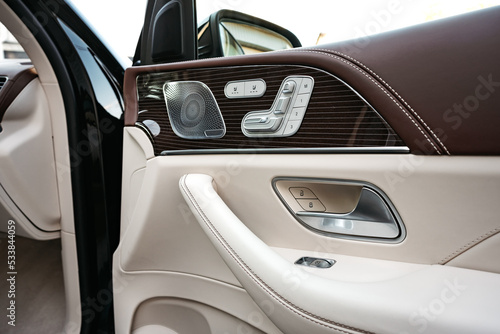 Front handle door panel with buttons of a luxury car © fotofabrika