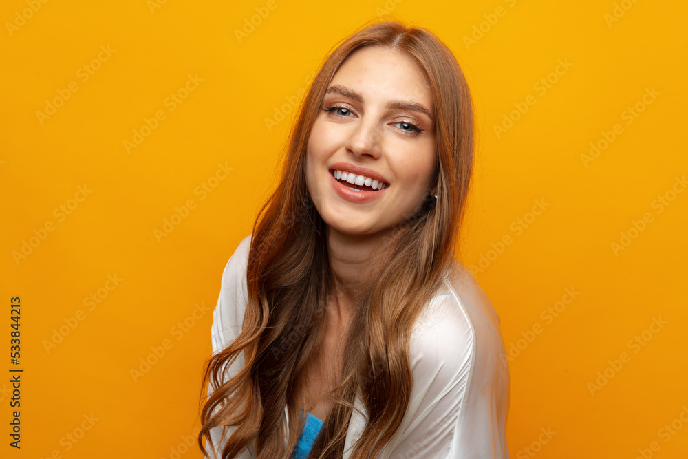 Pretty young woman smiling over yellow isolated background Pretty young woman smiling over yellow isolated background