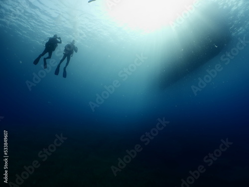 scuba divers around the boat for diving underwater scenery ocean