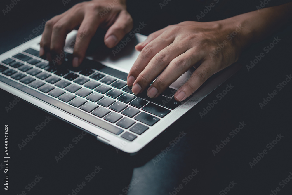 Man using computer laptop working internet searching social media and communications digital technology online at desk. Man using computer laptop working internet searching social media and communications digital technology online at desk.