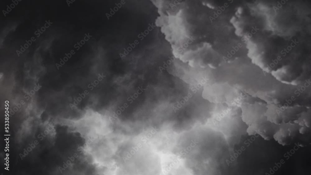 lightning flashes inside dark clouds in the dark sky. lightning flashes inside dark clouds in the dark sky.