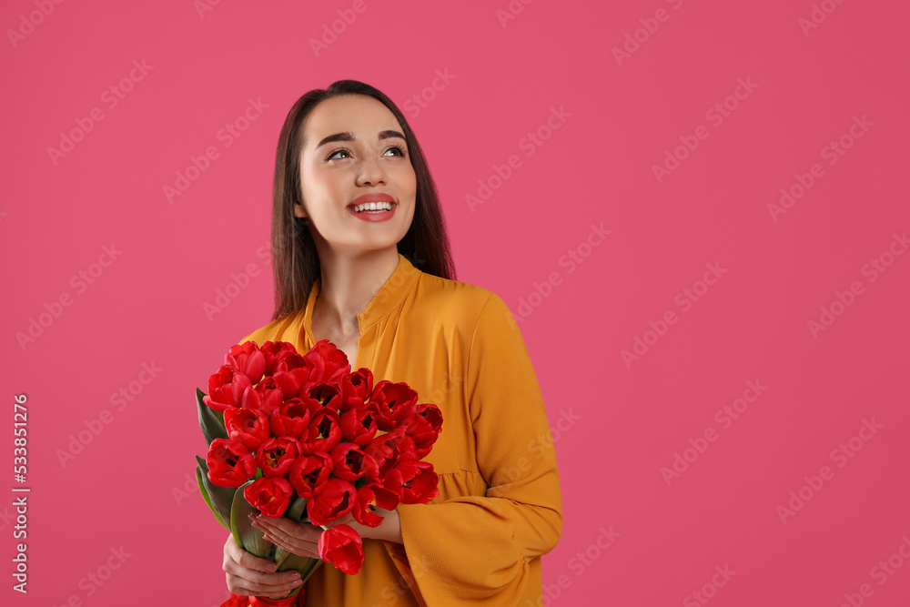 Happy woman with red tulip bouquet on pink background, space for text. 8th of March celebration Happy woman with red tulip bouquet on pink background, space for text. 8th of March celebration