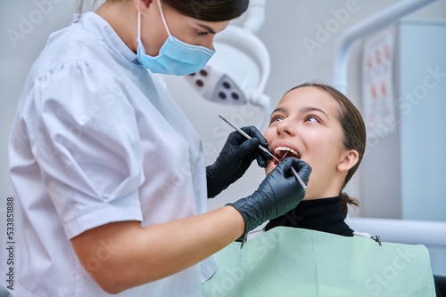 Young teenage female at dental checkup in clinic.