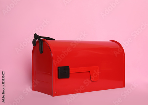 Closed red letter box on pink background