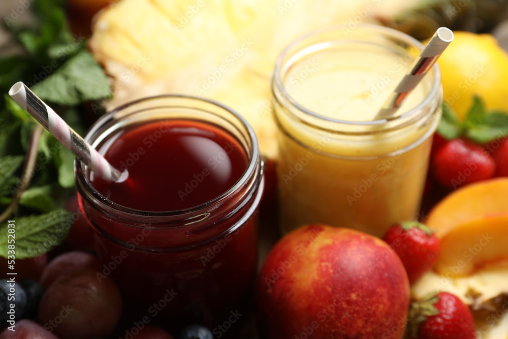 Delicious colorful juices in glasses and fresh ingredients on table, closeup Delicious colorful juices in glasses and fresh ingredients on table, closeup