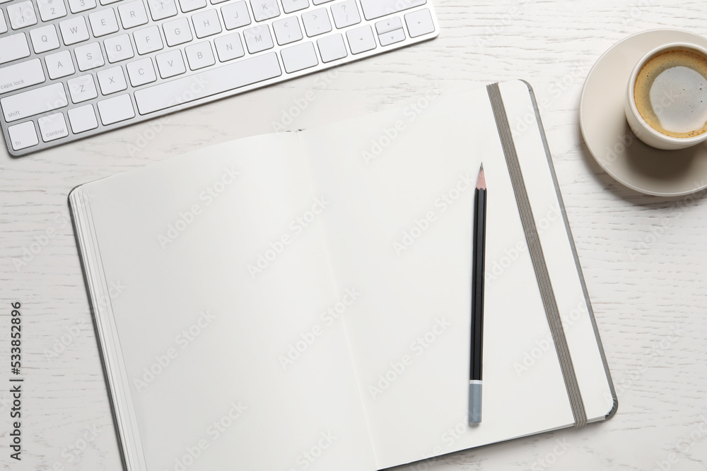 Open blank notebook, pencil, coffee and keyboard on white wooden table, flat lay Open blank notebook, pencil, coffee and keyboard on white wooden table, flat lay