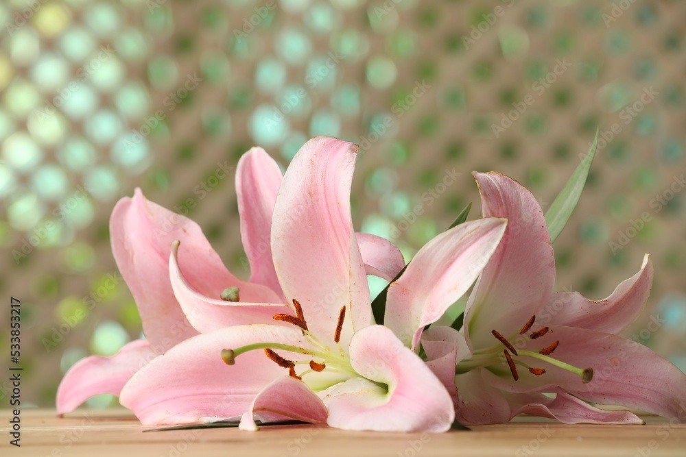 Beautiful pink lily flowers on wooden table