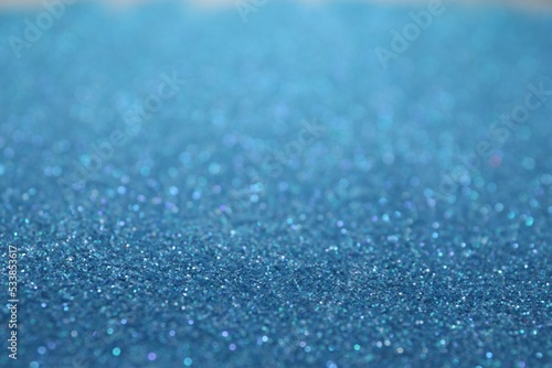 Shiny light blue glitter as background. Bokeh effect