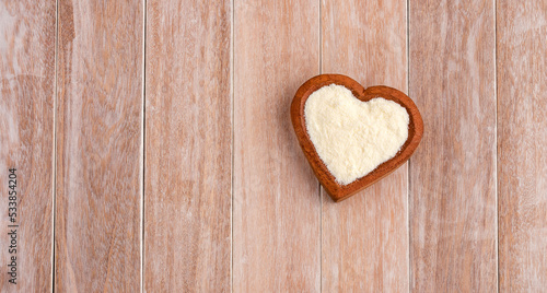 Powdered milk with nutrients in the heart shaped bowl