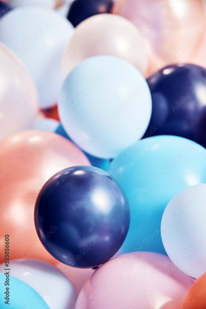 Stack of varicolored balloons in room
