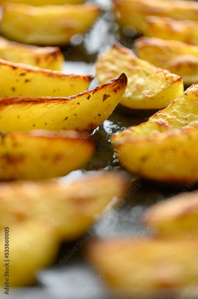 homemade potato wedges on a baking sheet homemade potato wedges on a baking sheet