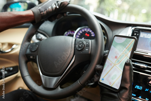 Taxi Driver Checking Map on Smartphone
