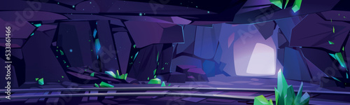 Underground emerald mine with green crystals. Cartoon vector illustration of dark mountain cave interior, many precious gemstones on walls and old railway for cart. Treasure mining game background