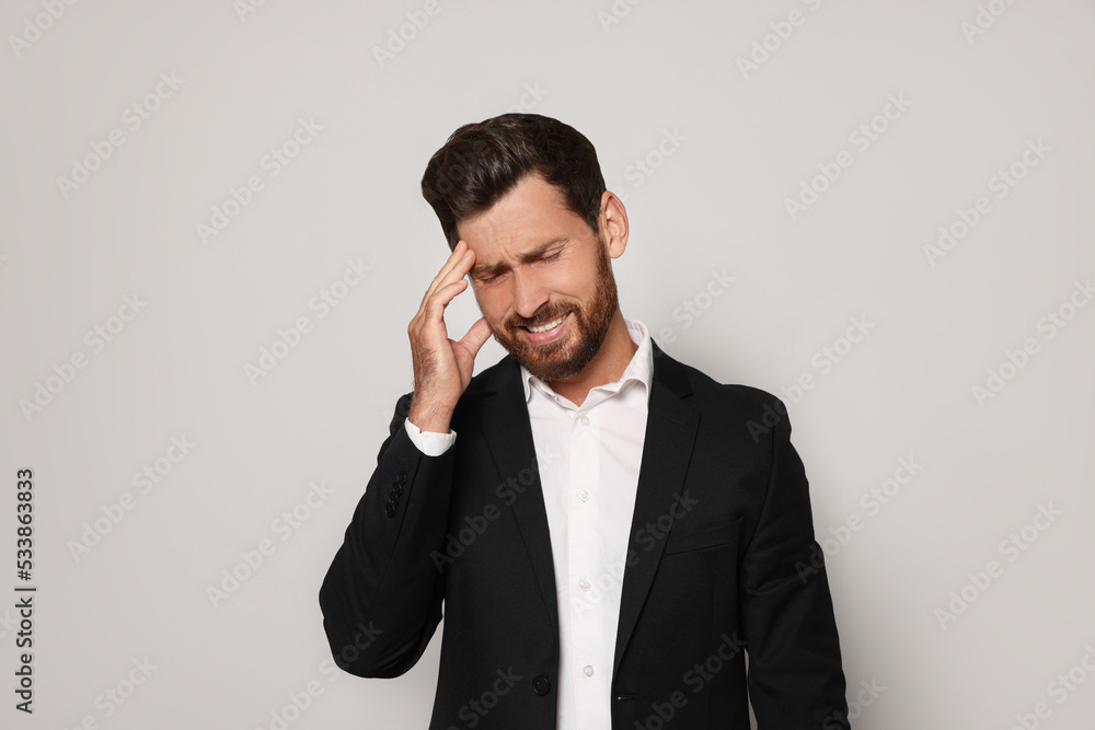 Stressed bearded man on light grey background Stressed bearded man on light grey background