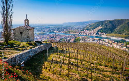 View on the Saint Christophe Chapel and the city of Tain l'hermitage with blooming red poppies and the vinyards of Chapoutier winery in the foreground