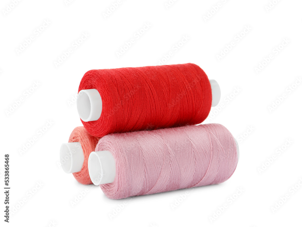 Different colorful sewing threads on white background
