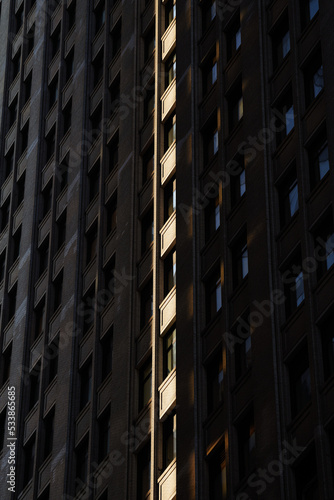 Isolated sun ray forming a line on the windows of a vintage skyscraper building from Manhattan, New York