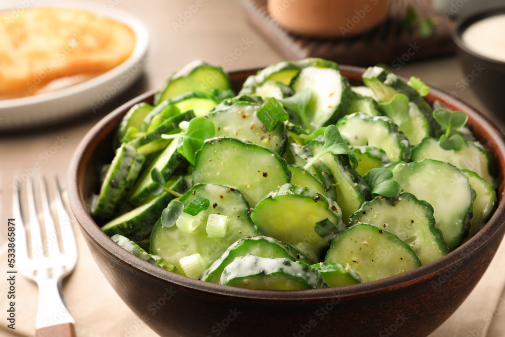 Delicious cucumber salad on wooden table, closeup Delicious cucumber salad on wooden table, closeup