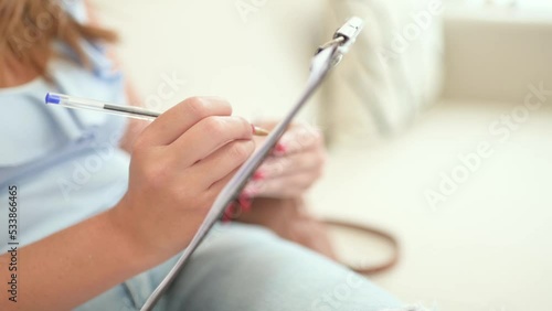 Crop client filling in form at reception