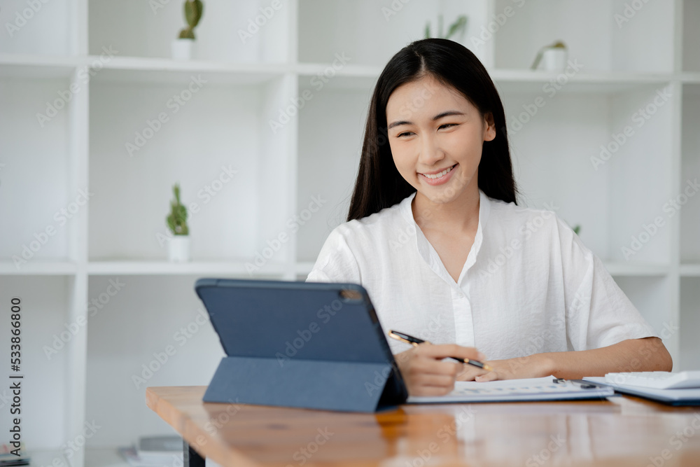 Asian woman working on laptop, female employee of a marketing company, she is working on a marketing plan for a company to generate income and profit, grow sales. Marketing planning concept. Asian woman working on laptop, female employee of a marketing company, she is working on a marketing plan for a company to generate income and profit, grow sales. Marketing planning concept.