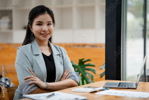 Portrait of a young beautiful Asian woman in a office room, concept image of Asian business woman, modern female executive, startup business woman, business leader woman.